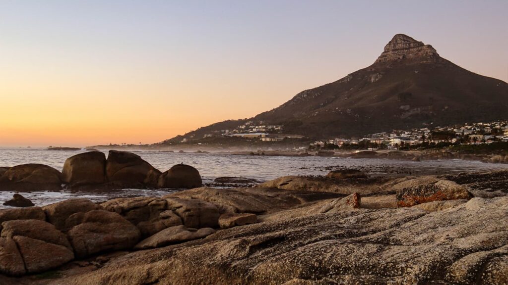 Lion’s Head mountain and Camps Bay coastline at sunset in Cape Town, highlighting natural beauty and luxury coastal living in South Africa