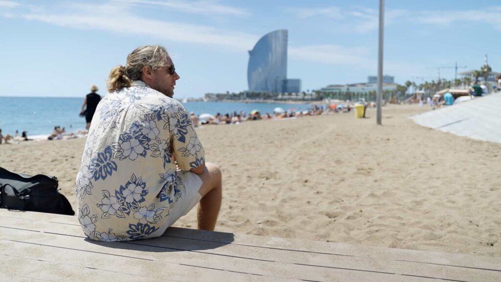 Former finance professional turned digital nomad enjoying beach life in Barcelona, reflecting on career change to performance marketing
