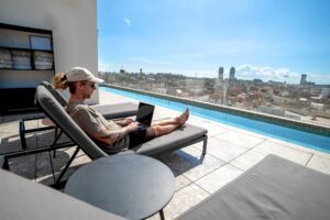 digital nomad using tax advantages and working from pool in Barcelona